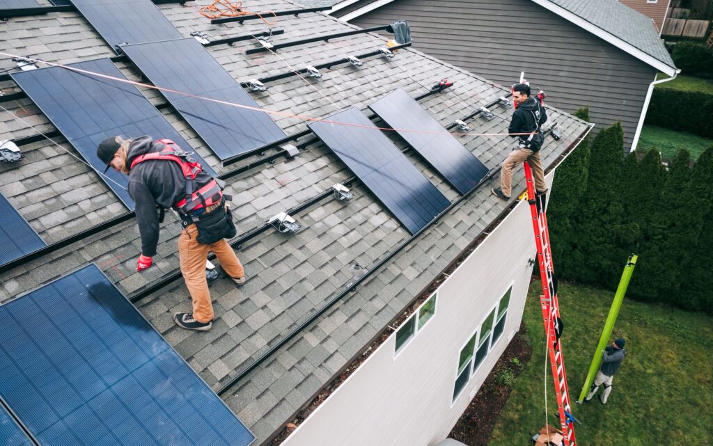 SolQ installer on an Illinois rooftop during a solar panel installation